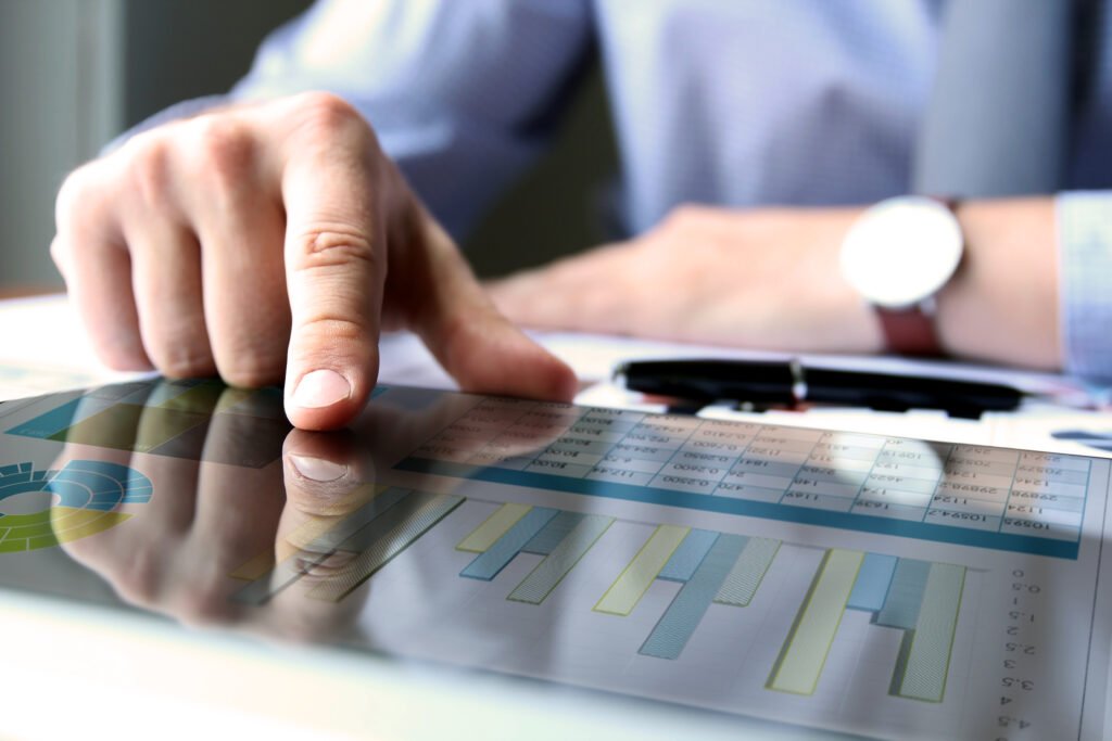 business man working and analyzing financial figures on a graphs