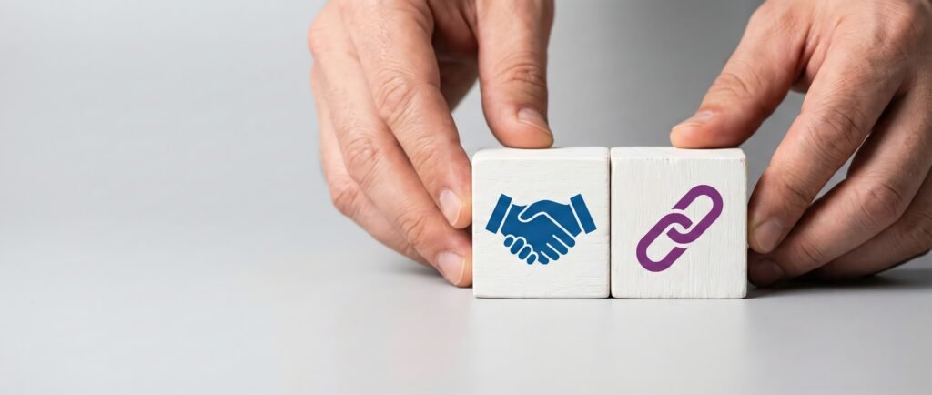 hands placing cubes with handshake and link icons, representing