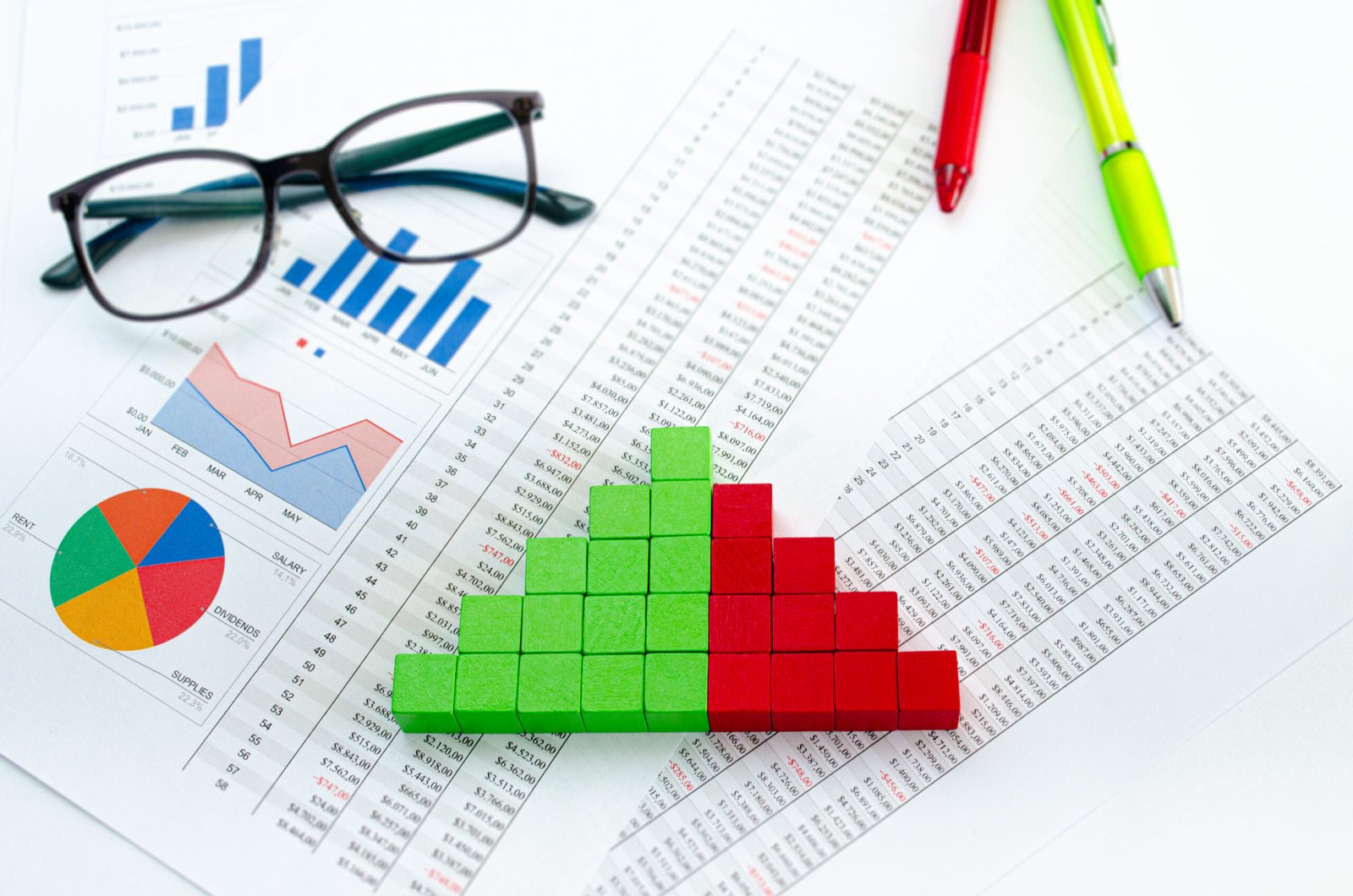financial documents, with green cubes arranged in a column graph