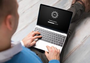 man installing software updates on laptop computer